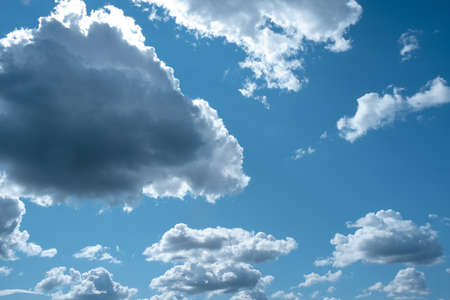 Dark white clouds on a blue sky in clear sunny weather.