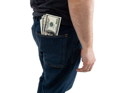 Unrecognizable man with dollars in his jeans pocket. Isolated on a white background.