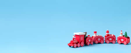 New Year's red train on a blue background. New Year, Christmas concept. Place for your text.の写真素材