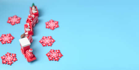 New Year's red train and snowflakes on a blue background. New Year, Christmas concept. Place for your text.の写真素材