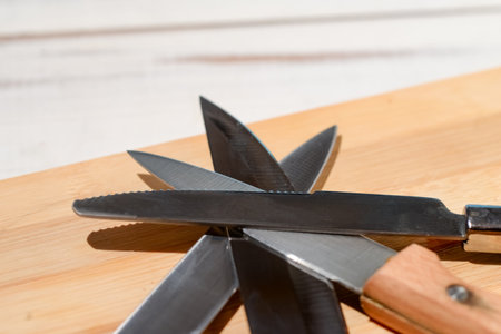 Different kitchen knives on a wooden background.の写真素材