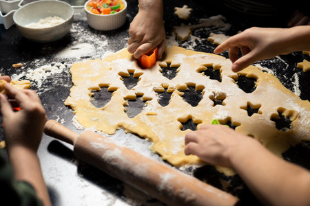 Children cook New Year's cookies together. Carving Christmas trees from dough. Preparation for the holiday. Joint team action.の写真素材