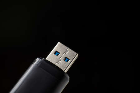 Flash drive close-up on a black background. Data safety concept.の写真素材