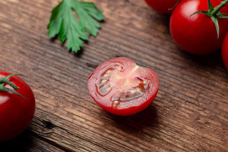 Sliced cherry tops on a wooden background.の写真素材