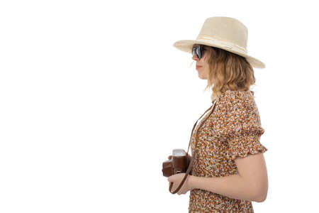Woman in sunglasses, brown dress in hat with retro camera isolated on white background.の写真素材