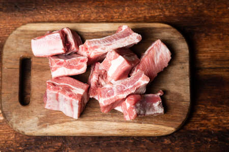 Pieces of fresh raw meat - pork ribs on a cutting board.
