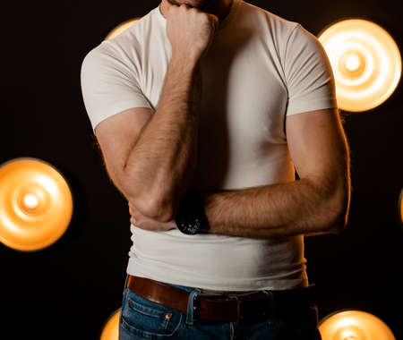 Stylish fashionable unrecognizable man in jeans and a white T-shirt.の写真素材