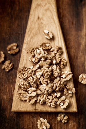 Peeled walnuts. On a wooden background. Healthy food. Natural background.の写真素材