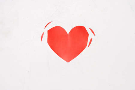 torn heart on a white background. Cheating, disappointment in love, unrequited love concept.