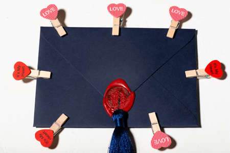 love letter concept. Blue envelope with heart pegs.