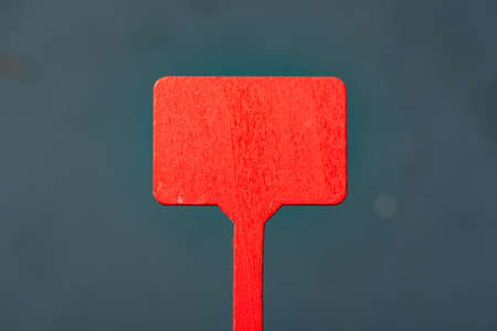 Red wooden plate on a dark background. Mock up.の写真素材