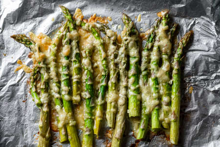Asparagus baked with cheese on a baking sheet. Vegetarian food. Health food.の写真素材