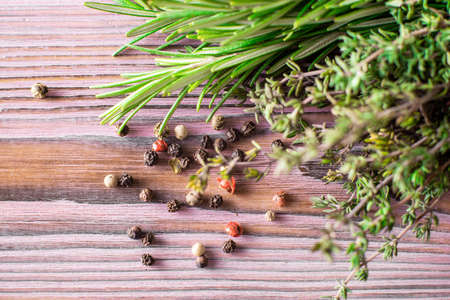 Thyme, pepper, rosemary on a purple wooden background. various spices.の写真素材