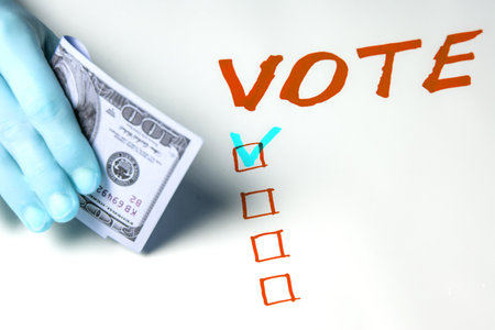 Buying votes of voters concept. A woman's hand holds one hundred US dollars on the background of the...