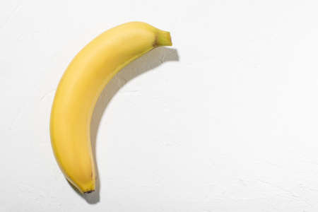 Banana on a white background. Whole unpeeled natural banana.の写真素材