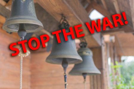 Stop war - inscription. Blurred background of church bells. An appeal to God, a prayer for an end to the war.の写真素材