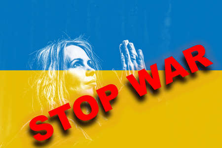 A woman in prayer against the background of the flag of Ukraine. stop war word. No Russian aggression.の写真素材