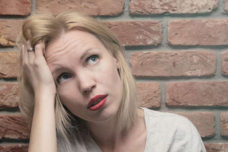 A woman with a sad face. The concept of women's problems, premenstrual syndrome.