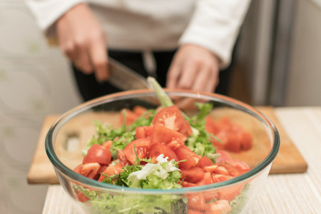Cooking salad from fresh vegetables.の写真素材