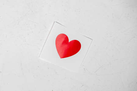Red paper heart on a white background. valentine's day concept. Declaration of love.