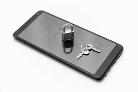 Electronic security and data protection concept. mobile phone and key lock.の写真素材