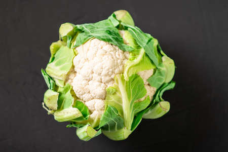 Whole cauliflower on a dark background. Vegetarian food.