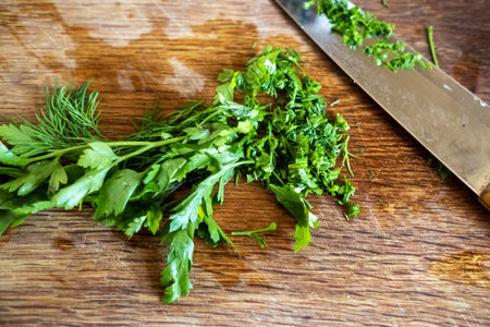 Fresh chopped parsley on a wooden cutting board. cooking food.の写真素材
