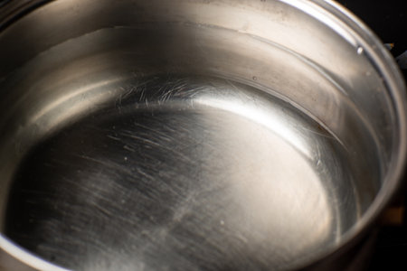 Water in a pot is on the stove in the kitchen. Preparation for boiling water.の写真素材