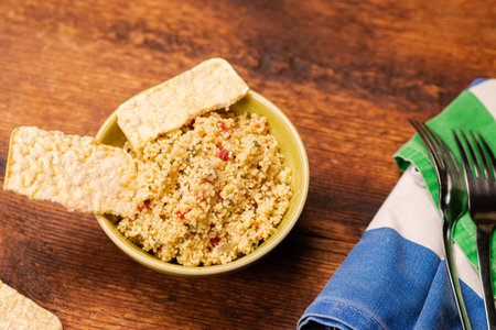 Rice bread and couscous tomato and spice salad. Tabbouleh salad. wooden background. Food simple...