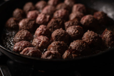 Meatballs in a frying pan. Making meatballs. dark background.の写真素材