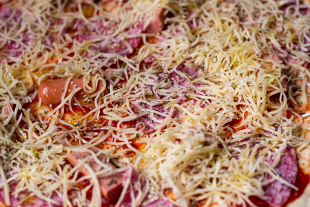 Pizza background. Cheese on raw pizza. food backgroundの写真素材
