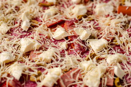 Raw homemade pizza close-up. Pizza background with mozzarella cheese and salami.の写真素材