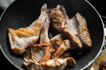 Raw rabbit with spices in a pan. Cooking stewed rabbit.の写真素材