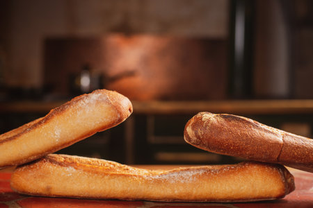 three French baguettes on the kitchen table. Place for text.