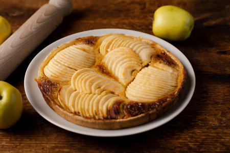 Cooked apple pie on wooden background. Finished semi-finished product.の写真素材