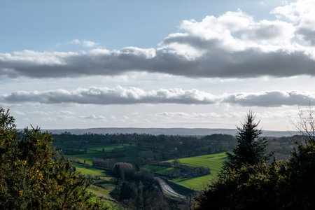 View of the countryside in France. Sky with clouds. Spacious volumetric view of the green meadows.