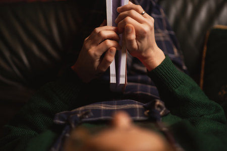 Women's hands on the book. top view. A woman is preparing to read a book, to study something.の写真素材