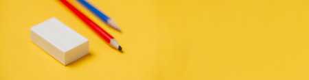 Eraser and pencils on a yellow background. Banner, place for text. stationery.