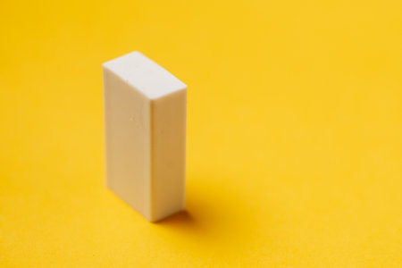 White eraser on a yellow background. stationery for school.の写真素材
