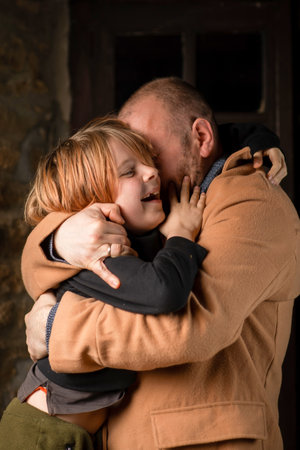 A man embraces his young son. Father's Day, the long-awaited meeting. A middle-aged man and a...