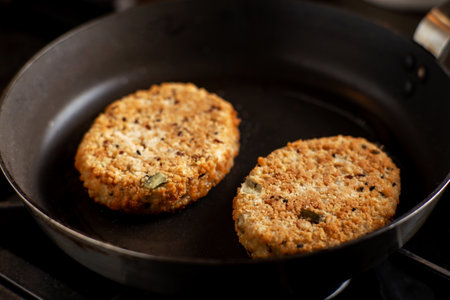 Vegetarian cutlets are fried in a pan. Meat alternative food. Cutlets from beans, seeds.の写真素材