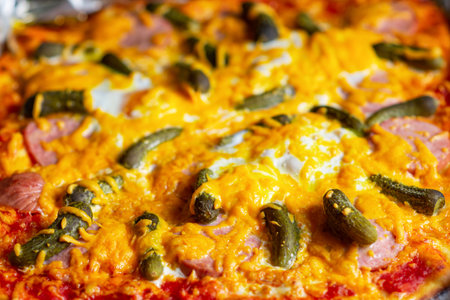 Pizza with pickled cucumbers. close-up. Surface of freshly cooked pizza.の写真素材