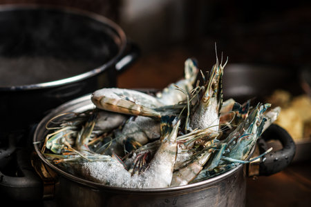 Cooking large king prawns in a pan on a dark background.の写真素材
