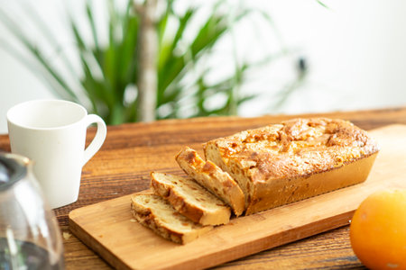 Homemade sliced cupcake on a wooden background.next to a cup of coffee. morning breakfastの写真素材