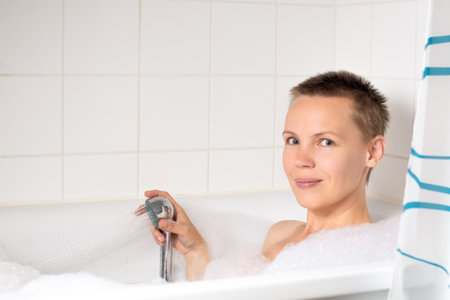 A woman with short hair enjoying a relaxing bubble bath