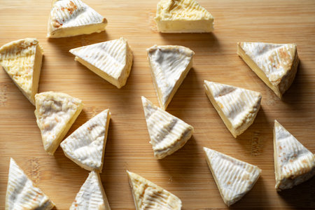 Sliced camembert cheese on a wooden surfaceの写真素材