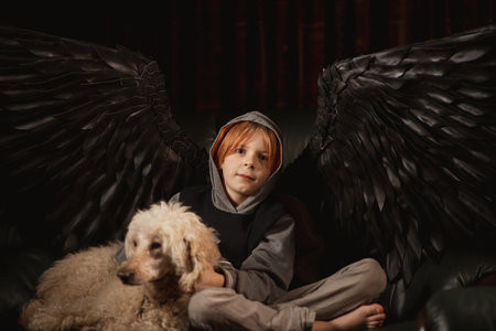 A boy and his dog are a reminder that even in the darkest of times, there is always hopeの写真素材