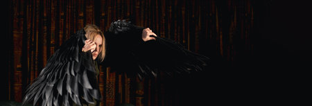 A woman is searching for light in the darkness. Banner, place for textの写真素材