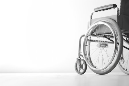Symbol of Hope: An empty wheelchair against a pristine white background, symbolizing the potential for mobility, freedom, and a blank canvas for new possibilities, banner, copyspaceの素材