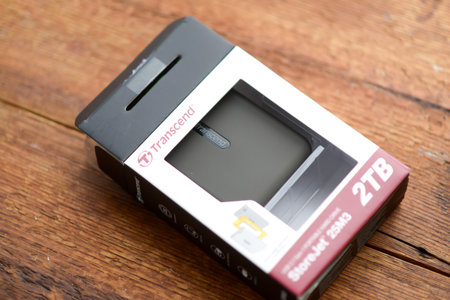 Caen, France - December 12, 2023: Unboxing a new Transcend portable hard drive on a wooden surface